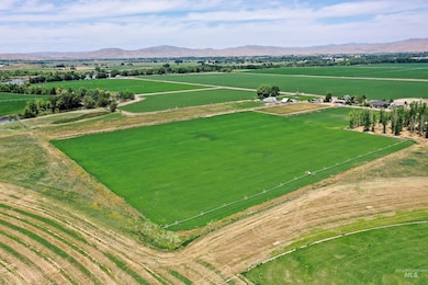 Overview of rural landscape with rows of crops and mountains