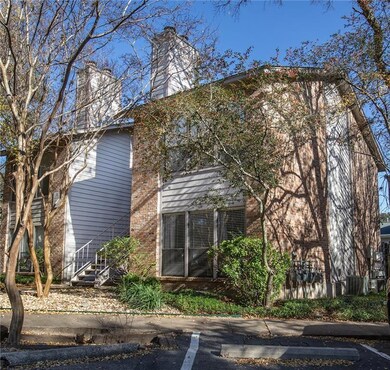 View of home's exterior with a chimney and brick 