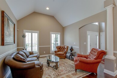 Formal Living Room has a vaulted ceiling, plantation shutters and opens to the Foyer and Dining Room.