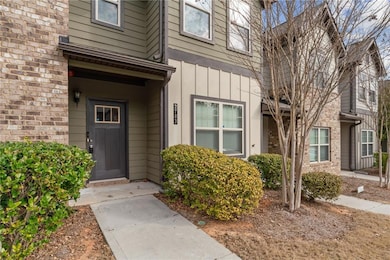 View of exterior entry featuring brick siding and 