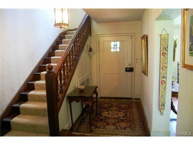 Foyer with lovely wood railing.