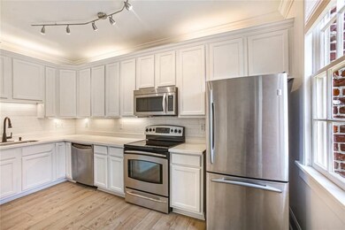 Kitchen has stainless steel appliances with cabine