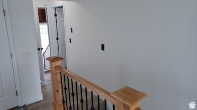 Hall with an upstairs landing and wood finished floors