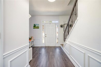 Foyer featuring dark wood finished floors, a decor