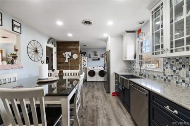 Kitchen featuring washer and tasteful backsplash,