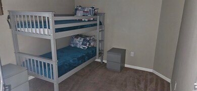 Carpeted bedroom featuring baseboards