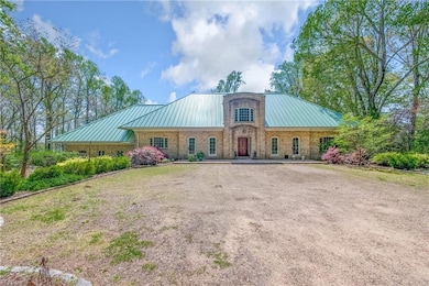 Front of home with abundant flowering landscaping