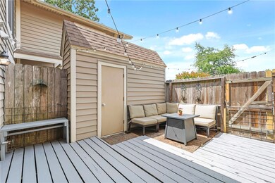 Wooden deck with fence, an outbuilding, and an out