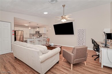 Living room with light hardwood / wood-style floor