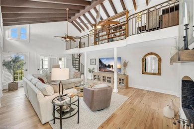 Living room featuring high vaulted ceiling, stairs