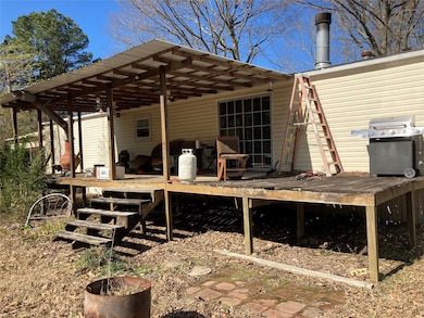 A back porch/decking that leads into the breakfast and living areas of this home.