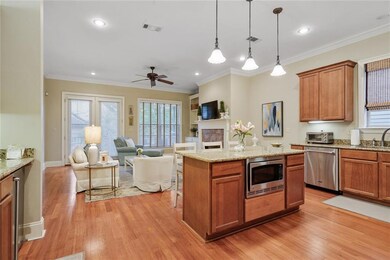 Kitchen has bar seating, wet bar, and is open to d