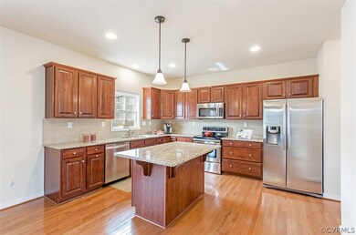 The open kitchen with island and granite counter t