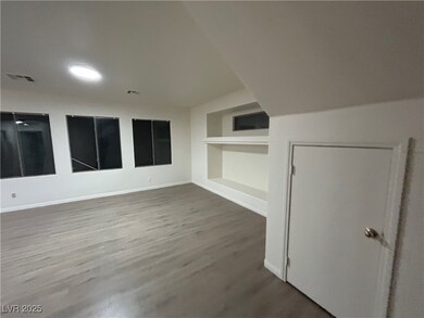 Additional living space featuring wood finished fl