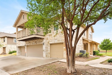 Multi unit property with stone siding, a balcony,