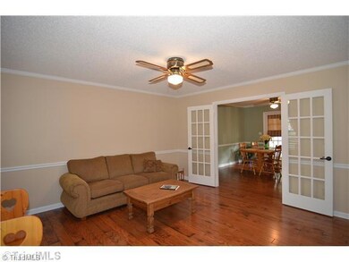 Living Room. Upon entering turn to your left and there is a very spacious Living Room.  Open the French Doors and enter the Dining Room.  Beautiful Hardwood Floors enhance this room as well as the majority of the first floor.