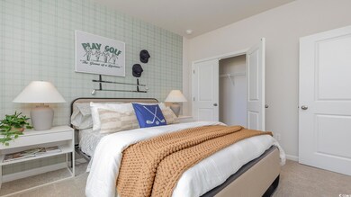 Carpeted bedroom featuring a closet
