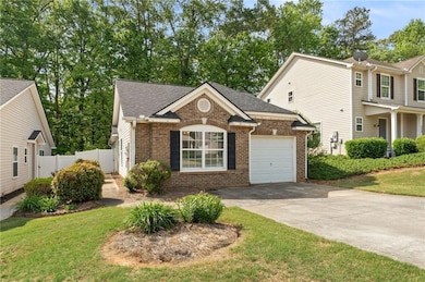 View of front of home featuring fence, an attached