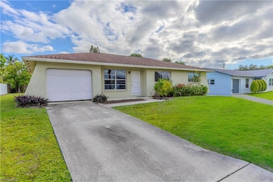 Single story home featuring stucco siding, a front yard, and a garage