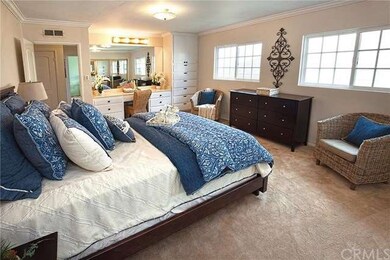 Large Master Bedroom with built-in vanity and floo