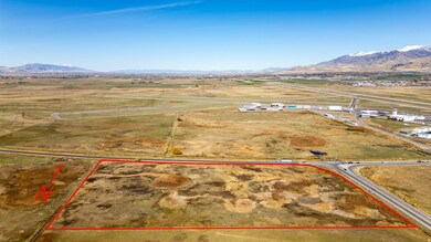 Overview of rural landscape featuring property parcel outlined and a mountain backdrop