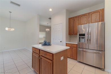 Kitchen with hanging light fixtures, stainless ste