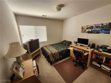 Carpeted bedroom with an office area
