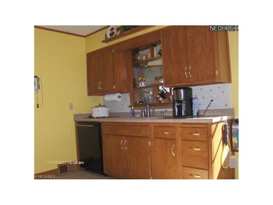 Kitchen prep area,solid oak cabinets, newer counter top, dishwasher and ceramic floor.
