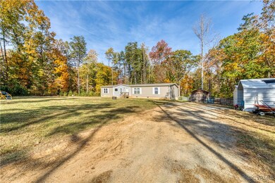 View of front of house with a storage shed