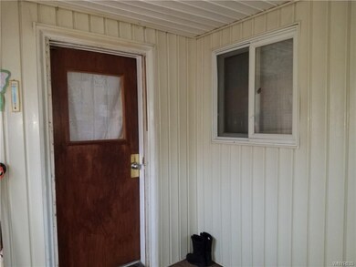 Large mudroom with two separate  entrances.