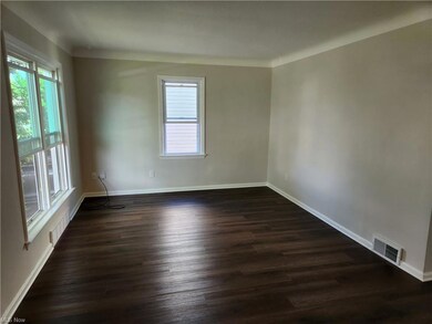 Wood floored spare room with a healthy amount of s