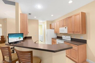 Kitchen with a breakfast bar area, light brown cab