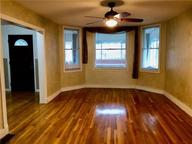 SPACIOUS LIVING ROOM WITH 3 WINDOW BAYS AND BEAUTI