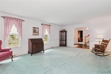 Sitting room featuring carpet floors, plenty of na