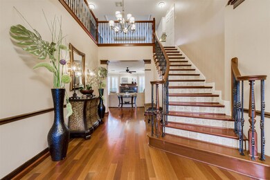 Inside you are greeted by a dramatic stair case and soaring ceilings. The stairs have tiled risers and wood treads with wrought iron railing up to the second floor.
