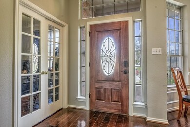 Entrance foyer with dark wood-style floors, a heal