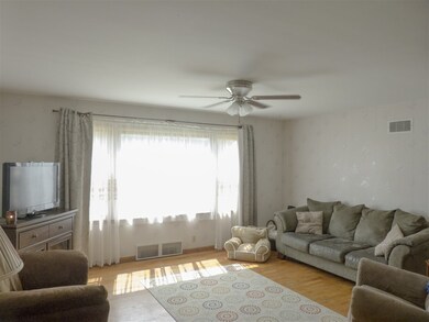 This large living room has hardwood floors.