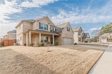 View of front of home with brick siding, an attached garage, driveway, a residential view, and covered porch