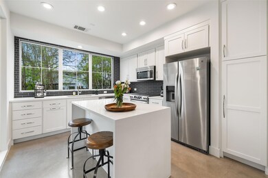 Kitchen featuring a sink, a breakfast bar area, c
