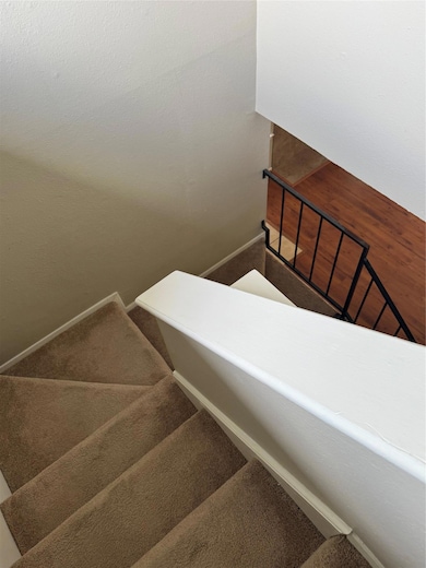 Stairs with carpet floors and baseboards
