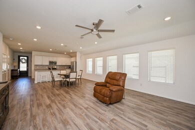 Step into a thoughtfully designed open-concept living space that harmonizes functionality with contemporary elegance. The room integrates the kitchen, dining, and living areas into a cohesive layout, ideal for both everyday living and entertaining.