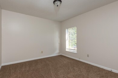Carpeted spare room with a textured ceiling