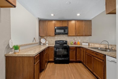 The kitchen blends functionality with warmth and features wood cabinets that offers ample storage space.