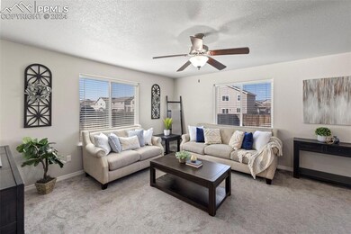 Living room with light carpet, and ceiling fan