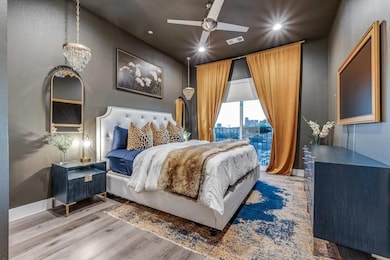 Bedroom with visible vents, baseboards, a textured