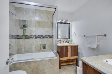 Bathroom with vanity, tiled shower / bath combo, 