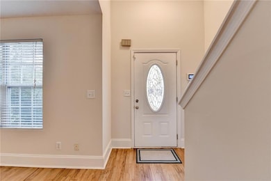 Entryway featuring baseboards and light wood finished floors