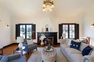 Batchelder tile fireplace under wooden casing.