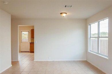 Unfurnished room with baseboards and light tile patterned flooring