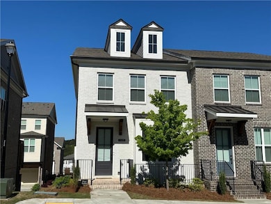Townhome featuring brick siding